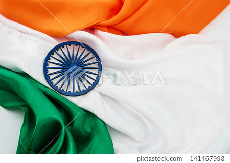 India flag with ashoka chakra on folded tricolor fabric India flag with ashoka chakra on folded tricolor fabric 141467998