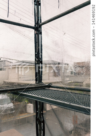 Metal scaffolding used for maintenance and management of apartment buildings Metal scaffolding used for maintenance and management of apartment buildings 141469192