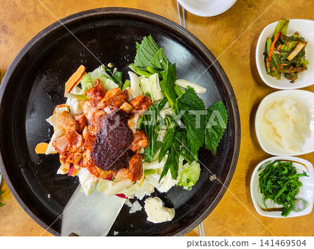 Spicy Korean Chicken Stir Fry Dakgalbi with Vegetables on Iron Pan Spicy Korean Chicken Stir Fry Dakgalbi with Vegetables on Iron Pan 141469504