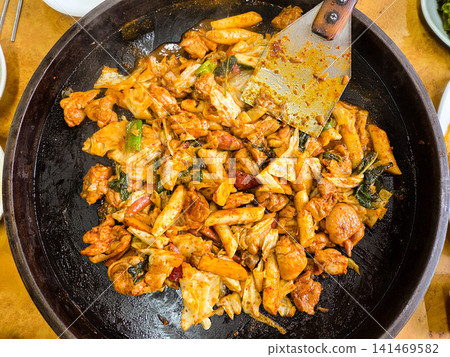 Spicy Korean Chicken Stir Fry Dakgalbi with Vegetables on Iron Pan Spicy Korean Chicken Stir Fry Dakgalbi with Vegetables on Iron Pan 141469582