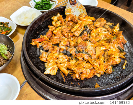 Spicy Korean Chicken Stir Fry Dakgalbi with Vegetables on Iron Pan 141469583
