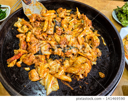 Spicy Korean Chicken Stir Fry Dakgalbi with Vegetables on Iron Pan Spicy Korean Chicken Stir Fry Dakgalbi with Vegetables on Iron Pan 141469590