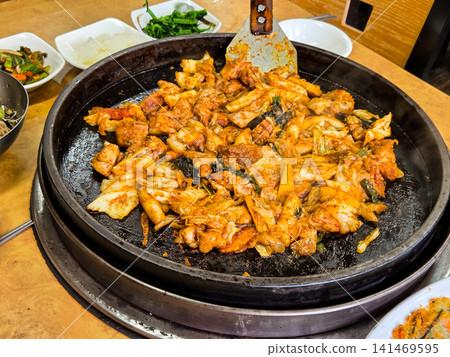 Spicy Korean Chicken Stir Fry Dakgalbi with Vegetables on Iron Pan Spicy Korean Chicken Stir Fry Dakgalbi with Vegetables on Iron Pan 141469595