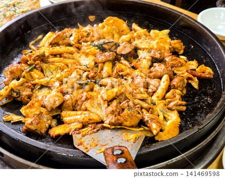 Spicy Korean Chicken Stir Fry Dakgalbi with Vegetables on Iron Pan Spicy Korean Chicken Stir Fry Dakgalbi with Vegetables on Iron Pan 141469598