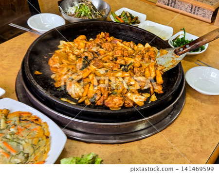 Spicy Korean Chicken Stir Fry Dakgalbi with Vegetables on Iron Pan 141469599