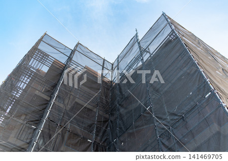 Exterior view of an apartment building undergoing renovation and major repairs. Exterior view of an apartment building undergoing renovation and major repairs. 141469705