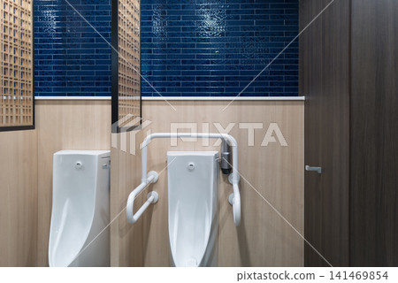 A modern men's restroom featuring wooden latticework and blue tiles. A modern men's restroom featuring wooden latticework and blue tiles. 141469854