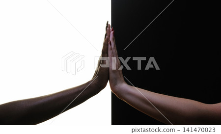 Diversity tolerance. Equality support. Silhouette of female hands touching palms together isolated on black white copy space background. Diversity tolerance. Equality support. Silhouette of female hands touching palms together isolated on black white copy space background. 141470023