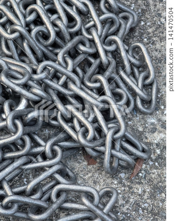 Close-up of haphazardly intertwined metal chains / Heavy texture suitable for industrial, security, and background materials. Close-up of haphazardly intertwined metal chains / Heavy texture suitable for industrial, security, and background materials. 141470504
