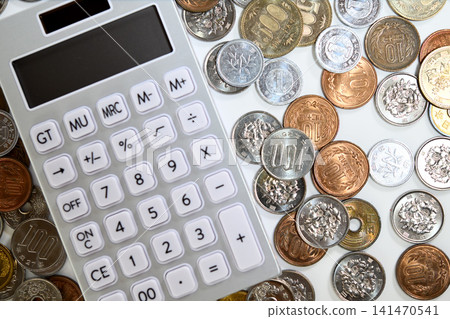 A calculator and Japanese yen coins A calculator and Japanese yen coins 141470541