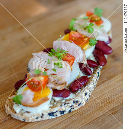 Healthy Open-Faced Chicken Sandwich with Soft-Boiled Egg, Kidney Beans and Cherry Tomatoes on Seeded Artisan Bread Healthy Open-Faced Chicken Sandwich with Soft-Boiled Egg, Kidney Beans and Cherry Tomatoes on Seeded Artisan Bread 141470557