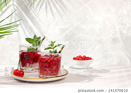 Mojito with sprite, mint and fresh berries,Detox water with raspberries, cherries, and currants, over ice. A refreshing summer homemade lemonade cocktail. Fruit juice and ingredients, Mojito with sprite, mint and fresh berries,Detox water with raspberries, cherries, and currants, over ice. A refreshing summer homemade lemonade cocktail. Fruit juice and ingredients, 141470610