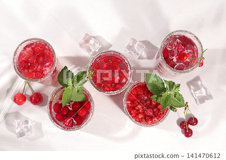 Dietary vegan water with raspberries, currants, and cherries, detox water, mojito with Sprite, mint, and fresh berries. Detox diet and weight loss concept, healthy lifestyle advertising, Dietary vegan water with raspberries, currants, and cherries, detox water, mojito with Sprite, mint, and fresh berries. Detox diet and weight loss concept, healthy lifestyle advertising, 141470612