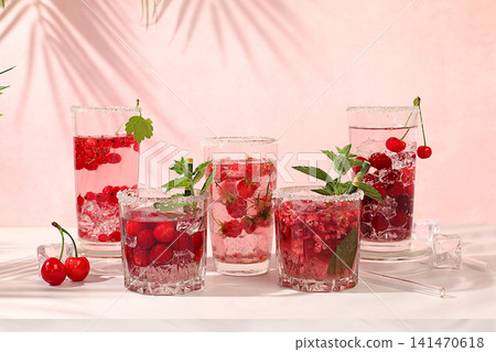Detox water with raspberries, cherries, and currants, over ice. A refreshing summer homemade lemonade cocktail. Fruit juice and ingredients, weight loss concepts, healthy and natural food, mojito Detox water with raspberries, cherries, and currants, over ice. A refreshing summer homemade lemonade cocktail. Fruit juice and ingredients, weight loss concepts, healthy and natural food, mojito 141470618