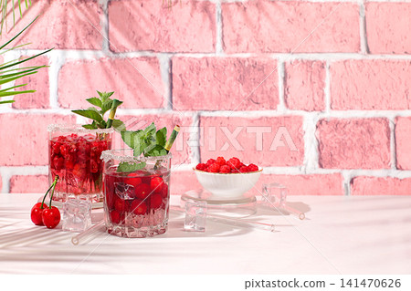 Mojito with sprite, mint and fresh berries,Detox water with raspberries, cherries, and currants, over ice. A refreshing summer homemade lemonade cocktail. Fruit juice and ingredients Mojito with sprite, mint and fresh berries,Detox water with raspberries, cherries, and currants, over ice. A refreshing summer homemade lemonade cocktail. Fruit juice and ingredients 141470626