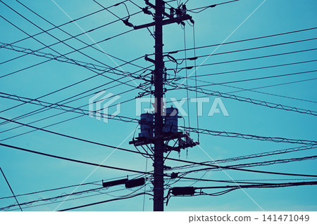 Blue sky and power lines, telephone poles Blue sky and power lines, telephone poles 141471049