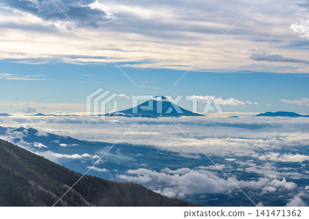 A spectacular view of the sea of clouds and Mt. Fuji from the summit of Mt. Nishigiboshi in the Yatsugatake Mountains. A spectacular view of the sea of clouds and Mt. Fuji from the summit of Mt. Nishigiboshi in the Yatsugatake Mountains. 141471362