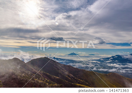A spectacular view of the sea of clouds and Mt. Fuji from the summit of Mt. Nishigiboshi in the Yatsugatake Mountains. A spectacular view of the sea of clouds and Mt. Fuji from the summit of Mt. Nishigiboshi in the Yatsugatake Mountains. 141471363