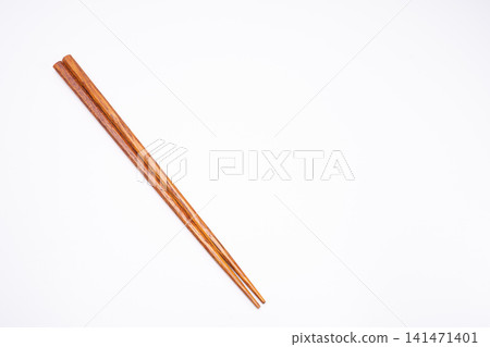 Wooden chopsticks conveying Japanese food culture against a clean white background. Wooden chopsticks conveying Japanese food culture against a clean white background. 141471401