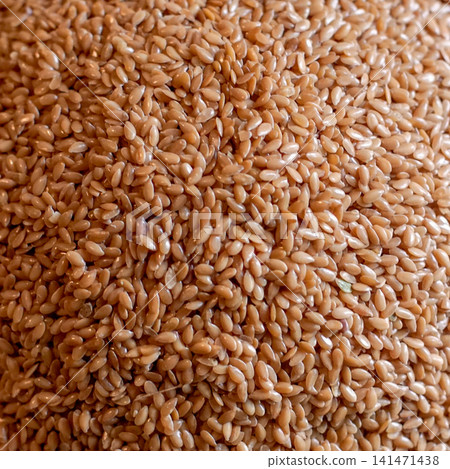 Close Up of Golden Flax Seeds and Whole Linseeds, Natural Healthy Food Ingredient Rich in Dietary Fiber for Organic Nutrition, Vegan Food and Wellness Background Close Up of Golden Flax Seeds and Whole Linseeds, Natural Healthy Food Ingredient Rich in Dietary Fiber for Organic Nutrition, Vegan Food and Wellness Background 141471438