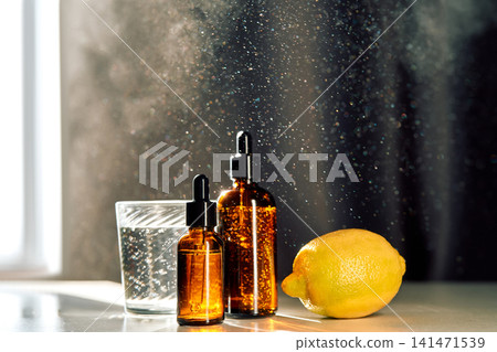 Cosmetic serum bottles with lemon and sparkling water Cosmetic serum bottles with lemon and sparkling water 141471539