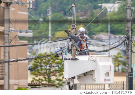 Electrical equipment installation, power lines, utility poles, work at heights, construction sites, fall protection equipment, full body harnesses Electrical equipment installation, power lines, utility poles, work at heights, construction sites, fall protection equipment, full body harnesses 141471779