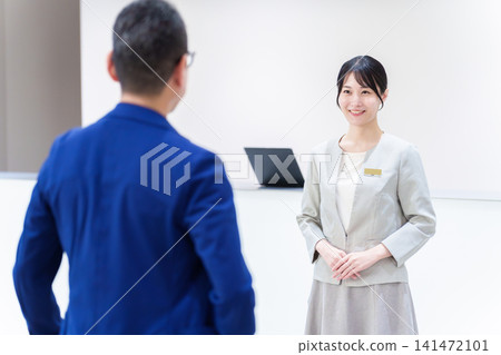 Female staff providing customer service at the hotel 141472101