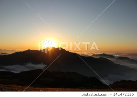A fantastical sunset viewed from Mt. Kamegamori in the Ishizuchi mountain range of Ehime Prefecture: A sea of clouds in the magic hour and the silhouette of Mt. Ishizuchi illuminated by the setting sun. A fantastical sunset viewed from Mt. Kamegamori in the Ishizuchi mountain range of Ehime Prefecture: A sea of clouds in the magic hour and the silhouette of Mt. Ishizuchi illuminated by the setting sun. 141472130