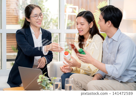 Asian couple in living room consulting with psychologist for marriage therapy. Asian couple in living room consulting with psychologist for marriage therapy. 141472589