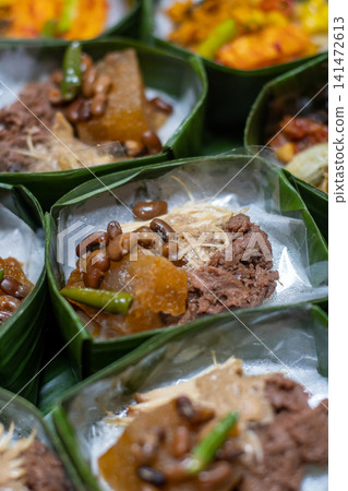 Traditional Gudeg Rice Meal in Banana Leaf Takir with Jackfruit Stew, Krecek and Chicken, Authentic Javanese Cuisine, Indonesian Heritage Food, Eco Friendly Food Presentation Traditional Gudeg Rice Meal in Banana Leaf Takir with Jackfruit Stew, Krecek and Chicken, Authentic Javanese Cuisine, Indonesian Heritage Food, Eco Friendly Food Presentation 141472613