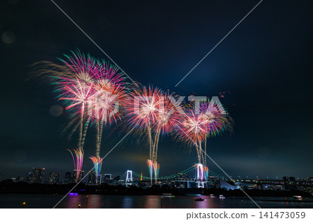 Colorful starbursts spread across the night sky Colorful starbursts spread across the night sky 141473059