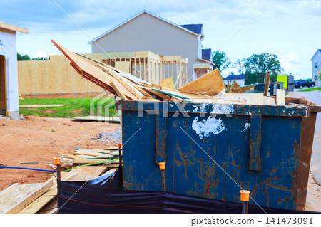 Workers are clearing waste materials from construction area where new homes are being built. Workers are clearing waste materials from construction area where new homes are being built. 141473091