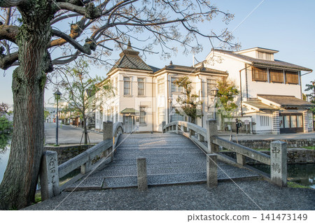 Kurashiki City, Okayama Prefecture: A clear day in the Kurashiki Bikan Historical Quarter, featuring the iconic Nakabashi Bridge and Kurashiki-kan. Kurashiki City, Okayama Prefecture: A clear day in the Kurashiki Bikan Historical Quarter, featuring the iconic Nakabashi Bridge and Kurashiki-kan. 141473149
