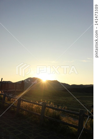 A scene of the sunrise over Kusasenrigahama in Aso City, Kumamoto Prefecture, featuring a vast grassland and pond bathed in the morning sun, and Mount Aso Nakadake with its rising plume of smoke. A scene of the sunrise over Kusasenrigahama in Aso City, Kumamoto Prefecture, featuring a vast grassland and pond bathed in the morning sun, and Mount Aso Nakadake with its rising plume of smoke. 141473389