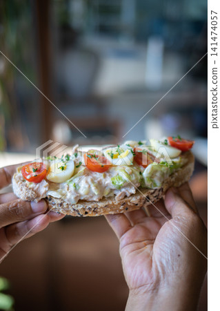 Healthy Open Sandwich with Boiled Egg, Cherry Tomatoes, Lettuce and Creamy Chicken Salad on Artisan Bread, Fresh Homemade Cafe Breakfast or Brunch Close Up Healthy Open Sandwich with Boiled Egg, Cherry Tomatoes, Lettuce and Creamy Chicken Salad on Artisan Bread, Fresh Homemade Cafe Breakfast or Brunch Close Up 141474057