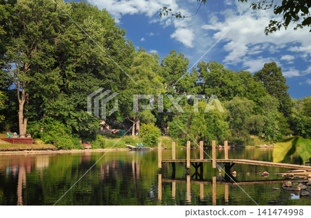 Beautiful view of Grand River in Grand Ledge with cloudy sky Beautiful view of Grand River in Grand Ledge with cloudy sky 141474998