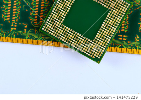 Computer chip is placed on green RAM circuit board many tracks gold pins along edges. Computer chip is placed on green RAM circuit board many tracks gold pins along edges. 141475229