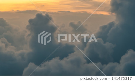 Hong Kong. July 26 2026 Golden sunset light glowing over thick cloud layers. Hong Kong. July 26 2026 Golden sunset light glowing over thick cloud layers. 141475317
