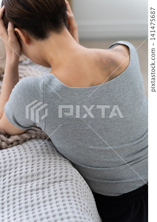 A woman with bruises on her back from domestic violence (special effects makeup) A woman with bruises on her back from domestic violence (special effects makeup) 141475687