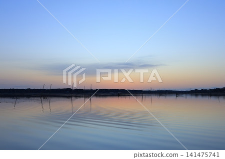 Morning glow reflected on the water surface Morning glow reflected on the water surface 141475741