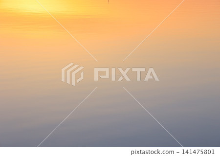 Morning glow reflected on the water surface Morning glow reflected on the water surface 141475801