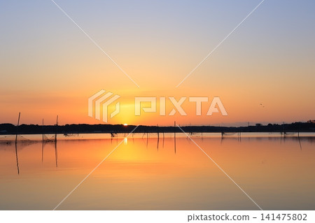 Morning glow reflected on the water surface Morning glow reflected on the water surface 141475802