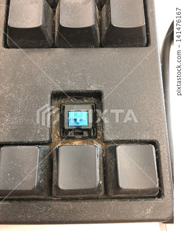 Close up of a computer keyboard with one keycap removed showing the switch. Close up of a computer keyboard with one keycap removed showing the switch. 141476167