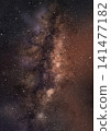 A brown galaxy surrounded by twinkling stars. 141477182
