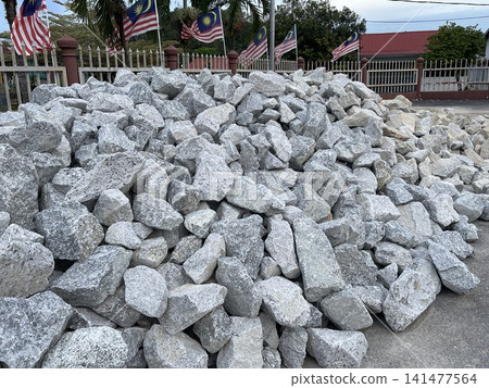 Pile of Construction Stones with Malaysian Flags in Background 141477564