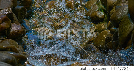 Rapid stream with fresh water among boulders and stones Rapid stream with fresh water among boulders and stones 141477844