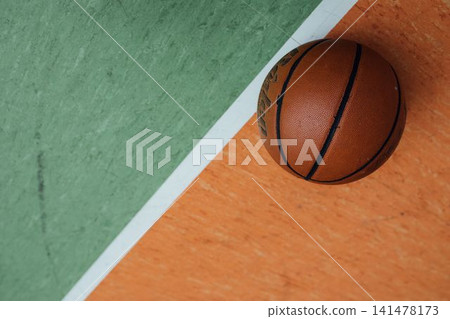 Basketball Resting on an Indoor Court Floor Line Basketball Resting on an Indoor Court Floor Line 141478173