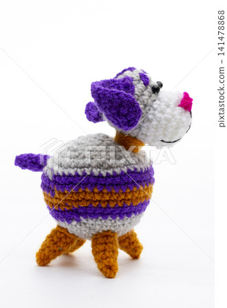 Knitted woolen dog on a white background Knitted woolen dog on a white background 141478868