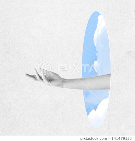 Hand reaching out from monochrome reality to colorful sky portal 141479133