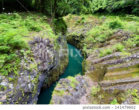 The Manai Falls and the magnificent columnar jointed gorge scenery can be seen in Takachiho Gorge in Takachiho Town, Miyazaki Prefecture. The Manai Falls and the magnificent columnar jointed gorge scenery can be seen in Takachiho Gorge in Takachiho Town, Miyazaki Prefecture. 141479602